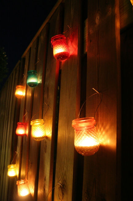 homemade mosquito repellent candles on the fence
